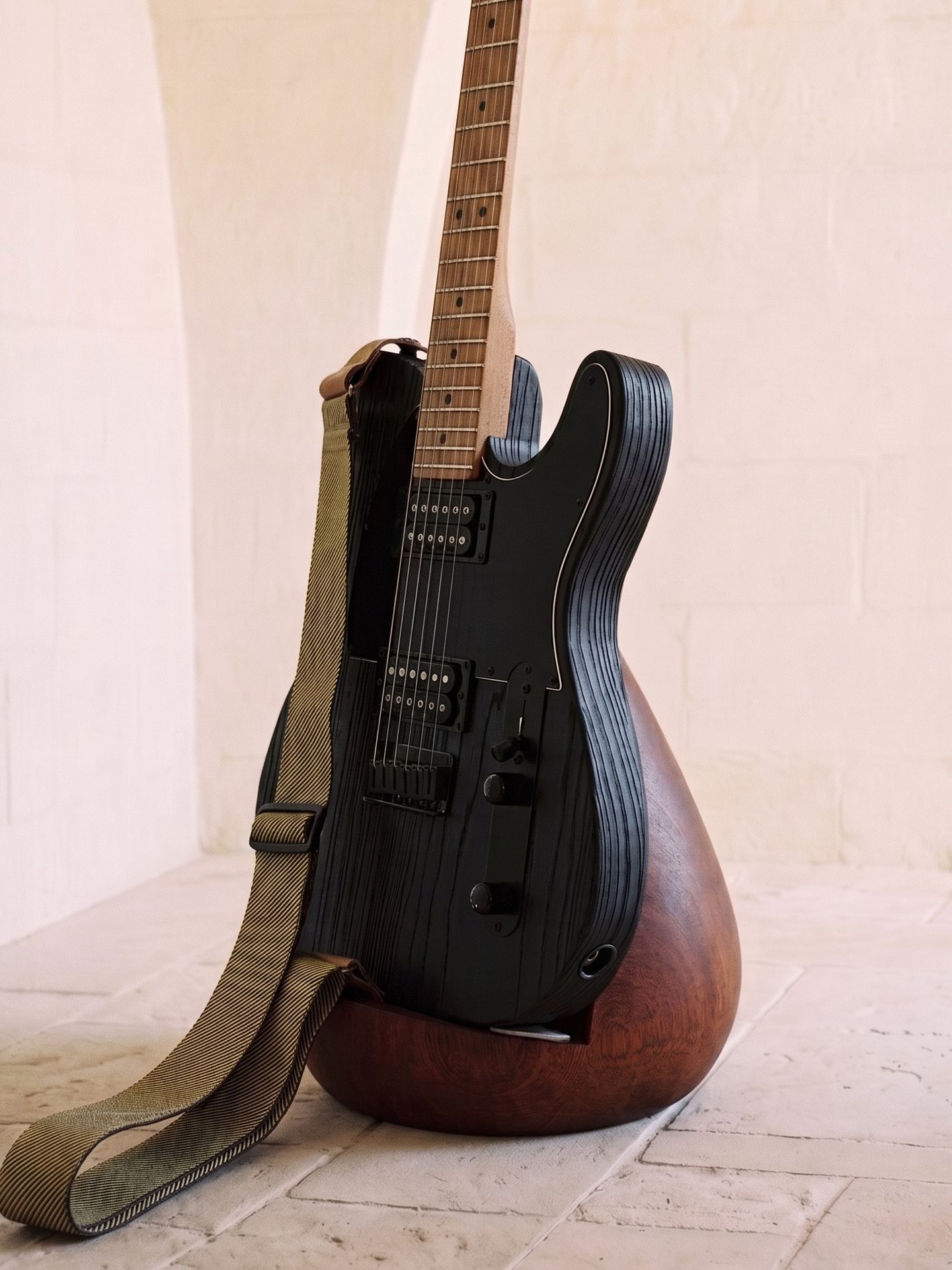 Telecaster noire sur la Stèle en bois foncé